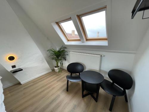 a dining room with two chairs and a table at D28 Bruges in Bruges
