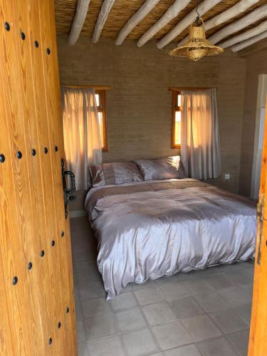 a bedroom with a large bed in a room at Dar Tiziri Amizmiz in Marrakech