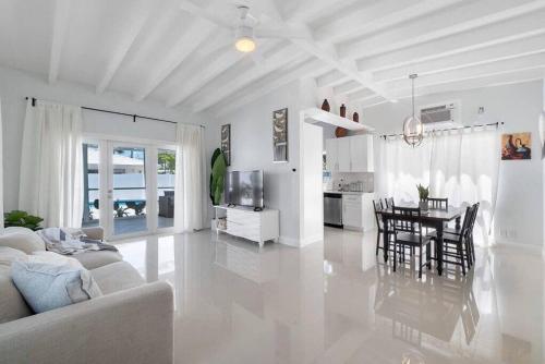 a white living room with a couch and a table at Together but with Privacy 3 Units and Private Pool in Fort Lauderdale