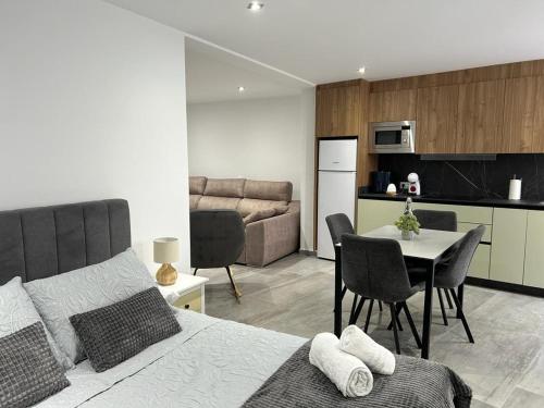 a bedroom with a bed and a table and a kitchen at Gaviotas Beach Golf in Almerimar