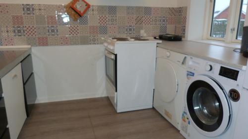 a kitchen with a washing machine and a counter at (id. 099) Grønnevej 35 in Esbjerg