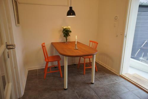 a dining room table with two chairs and a candle on it at (id. 099) Grønnevej 35 in Esbjerg
