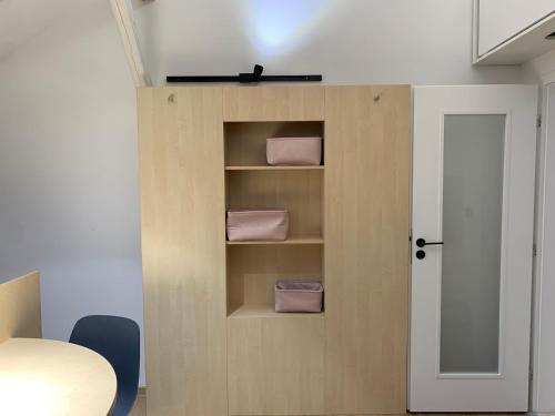 a room with a door with three pink towels at Hotel Desatero in Mikulov