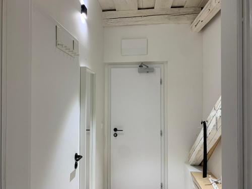 a hallway with a white door and a white wall at Hotel Desatero in Mikulov