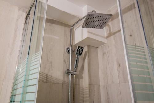 a shower with a glass door in a bathroom at 2 Bedrooms Apartment close to metro Dafni in Athens in Athens