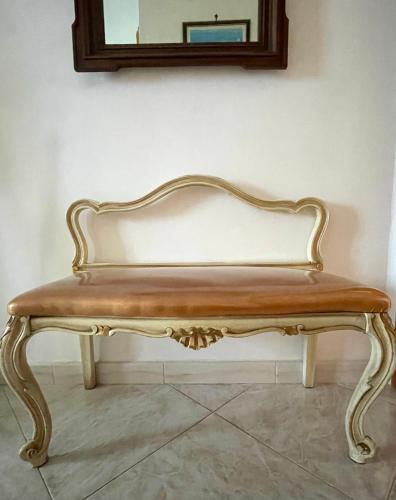 a bench sitting in a room with a mirror at Seafront View in Mola di Bari