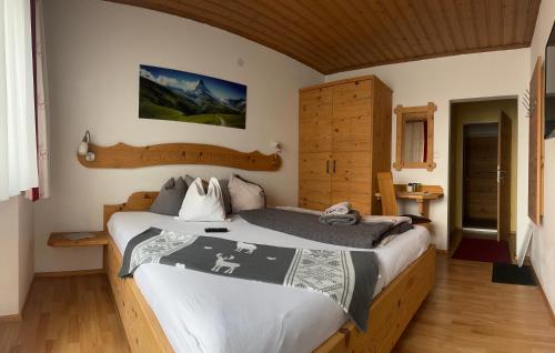 a bedroom with a large bed in a room at Haus Voithofer in Sankt Johann im Pongau