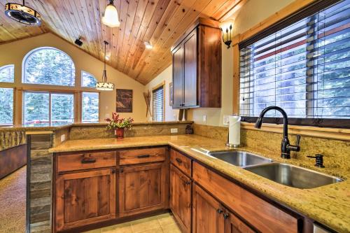 a kitchen with wooden cabinets and a sink at Lake Tahoe Cabin with Private Beach Access in Tahoma