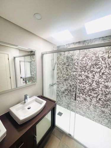 a bathroom with a shower and a sink and a mirror at Espacioso Bungalow en Maspalomas in Maspalomas