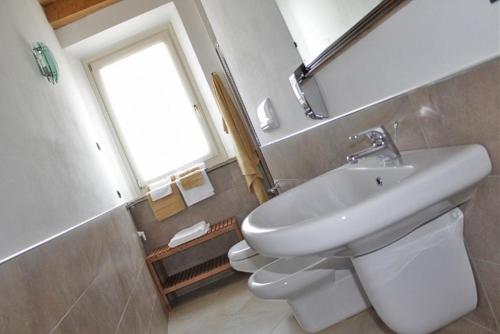 a bathroom with a sink, toilet and tub at La Filanda in Brescia