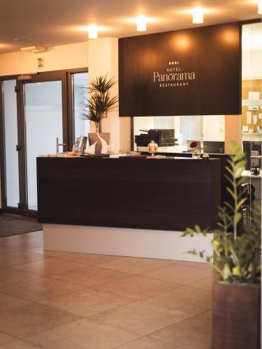 a restaurant with a counter with a sign on it at Hotel Panorama in Rablà