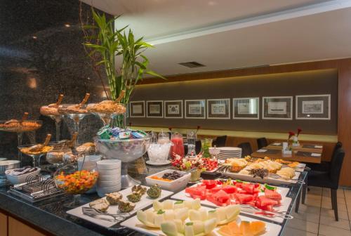 a buffet with many different types of food on a table at Promenade Palladium Leblon in Rio de Janeiro