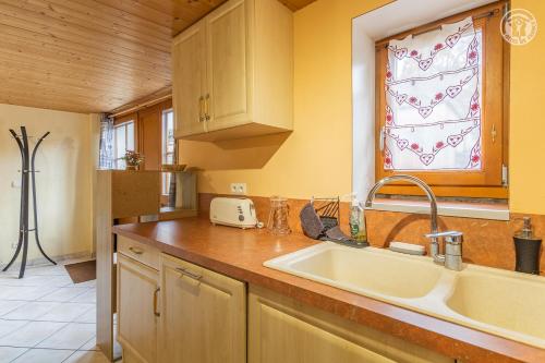 a kitchen with a sink and a window at Gîte Le Tsozal in Aussois