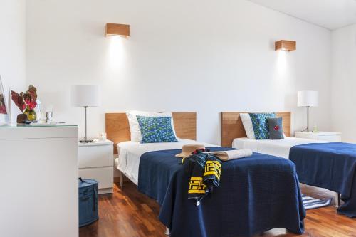 a bedroom with two beds with blue sheets at Monte Beato in Almodôvar