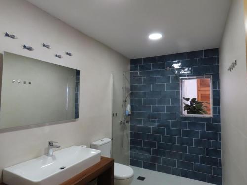 a bathroom with a sink and a toilet and a mirror at Can Mariano Mayans in Sant Francesc Xavier