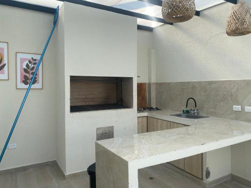 a kitchen with a counter top and a sink at Casa kalumaye ibague in Ibagué