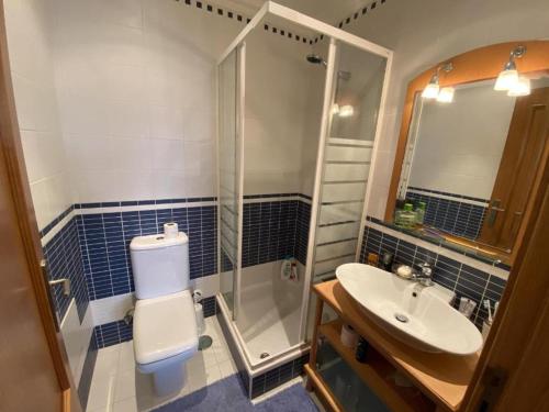 a bathroom with a sink and a shower and a toilet at APARTAMENTO VISTA MAR in Lourinhã