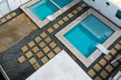 an overhead view of two swimming pools on a building at Centrally located Villa with 3 Pools -Food & Beach walking distance in Arecibo