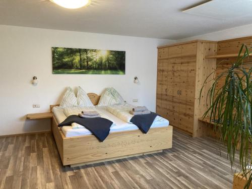 a bedroom with a wooden bed in a room at Haus Voithofer in Sankt Johann im Pongau