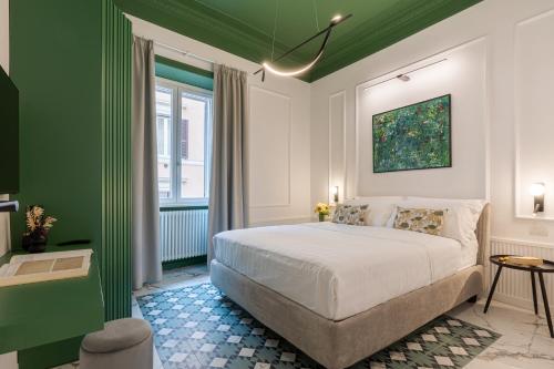 a green and white bedroom with a bed and a window at The Romulus in Rome