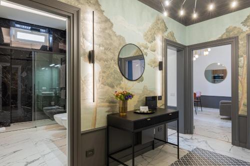 a bathroom with a vanity and a mirror at The Romulus in Rome