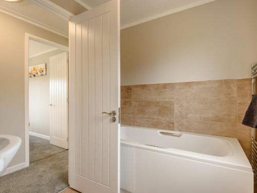 a bathroom with a white tub and a sink at 2 Bed in Kinlet 92659 in Kinlet