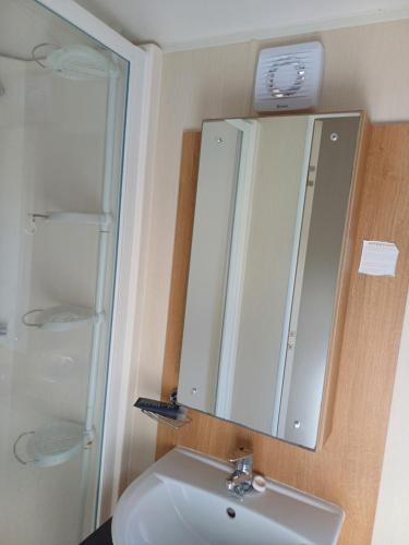 a bathroom with a sink and a mirror at Caravan Holiday Home @ Marton Mere, BLACKPOOL in Blackpool