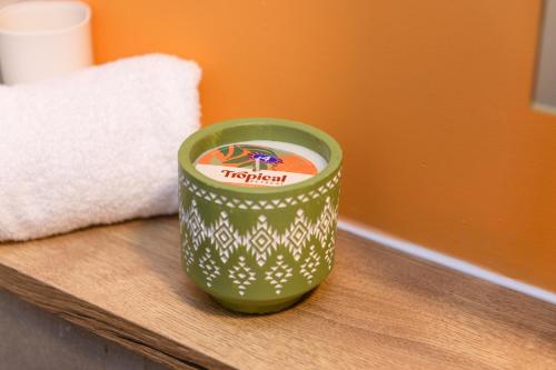 a green cup sitting on top of a table at Benjamin Suite by Koya Homes - 3 Double Bedroom Apartment, Cardiff City Centre, Free Parking in Cardiff
