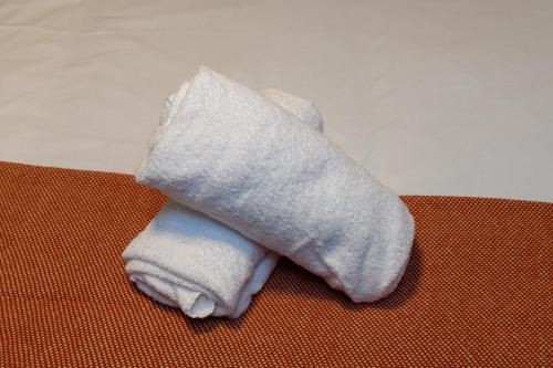 a towel sitting on top of a table at Benjamin Suite by Koya Homes - 3 Double Bedroom Apartment, Cardiff City Centre, Free Parking in Cardiff