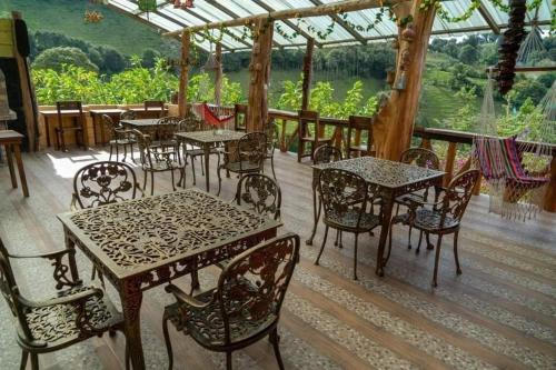 a group of tables and chairs in a restaurant at Orquideas Runtun in Baños