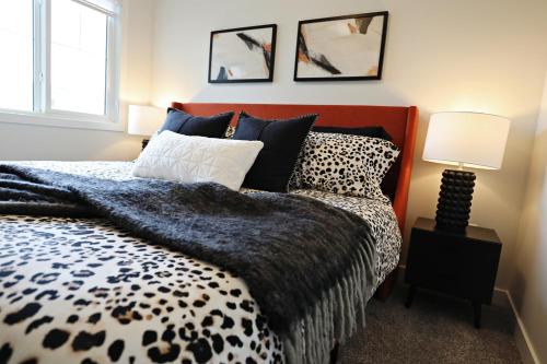 a bedroom with a black and white bed and a window at Stylish Home with AC, 3 King Beds, Garage, Disney in Edmonton