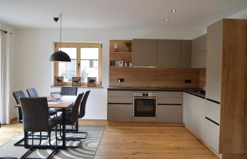 a kitchen with a table and chairs in a room at Chalet Groissenbach in Reit im Winkl