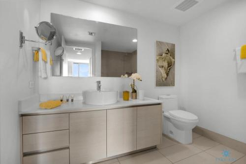 a bathroom with a sink and a toilet at Infinite View with Balcony,Pool plus Near Beach in Hallandale Beach