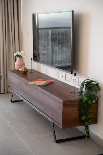 a dresser with a large mirror on top of it at Savion View City Center Jerusalem in Jerusalem