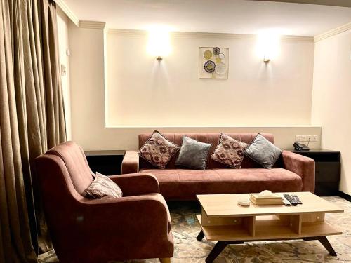 a living room with a couch and a coffee table at Al-Sadier Place Hotel & Restaurant in Baghdad