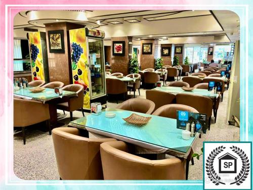 a dining room with tables and chairs in a restaurant at Al-Sadier Place Hotel & Restaurant in Baghdad
