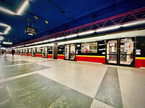 a subway train at a station with its doors open at SAWA 6 metro fast WiFi 70'TV panorama HBO, Netflix, Dsiney+ in Warsaw