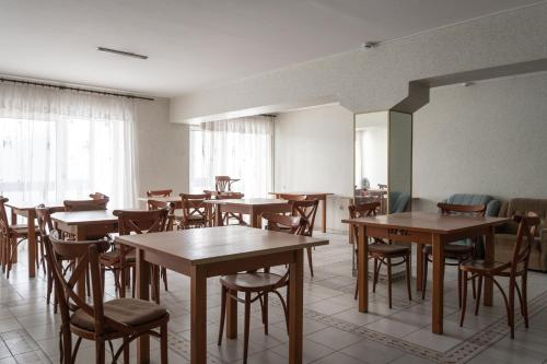 a dining room with wooden tables and chairs at готель Моряк in Chornomorsk