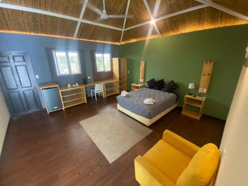 an overhead view of a bedroom with a bed and a couch at Grand Park Manuel Antonio - Adults Only in Manuel Antonio