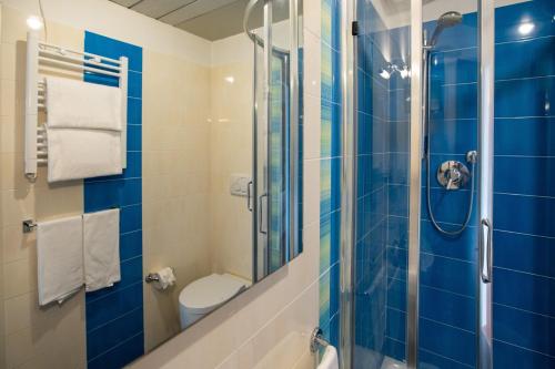 a bathroom with a toilet and a glass shower at Hotel Palace del Conero in Osimo