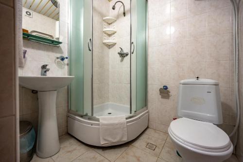 a bathroom with a shower and a toilet and a sink at готель Моряк in Chornomorsk