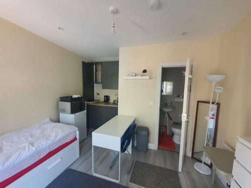 a small room with a bed and a kitchen at Private Ensuite Room with Kitchenette in Phibblestown