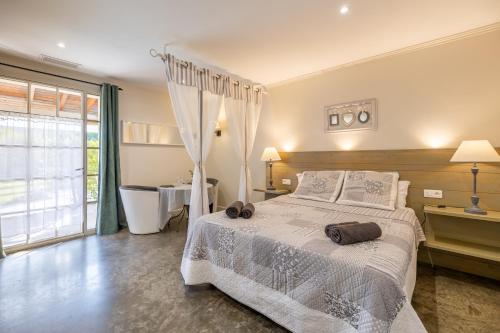 a bedroom with a white bed and a bathroom at Residence Melody - Adult only in Saint-Rémy-de-Provence