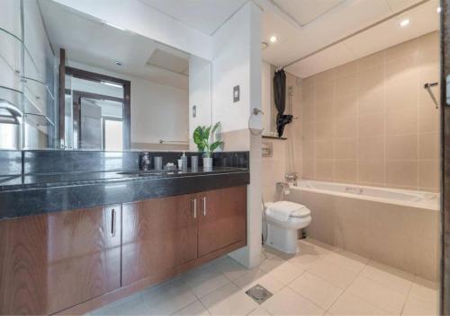 łazienka z umywalką, toaletą i wanną w obiekcie One of a Kind! One Bedroom with Downtown Views w Dubaju