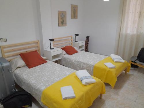 a room with two beds with towels on them at Apartamento EuroRental con WiFi in Santa Cruz de Tenerife