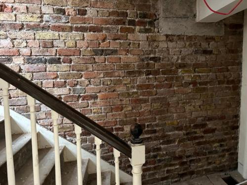 a brick wall with a staircase in front of a building at Patrick Street Townhouse in Cork