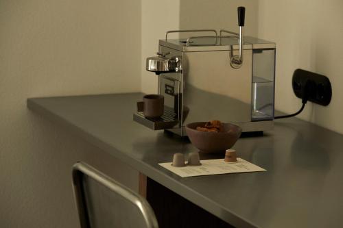 a counter with a coffee maker and a bowl on it at Ergon Bakehouse Athens in Athens