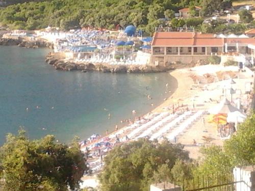a beach with a bunch of people on the water at Apartment Carpe Diem in Utjeha