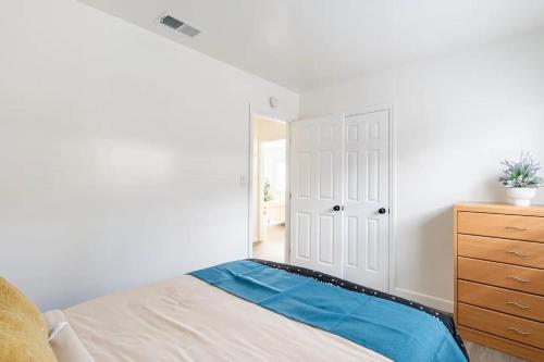 a white bedroom with a bed and a dresser at Newly Renovated 2BR 1BA Near San Jose Downtown up to 20 percent off in San Jose