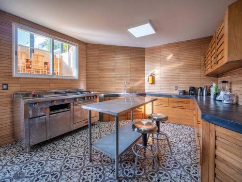 a large kitchen with a table and a stove at Casa Maka - Stunning Oceanfront Villa in Santa Cruz Huatulco